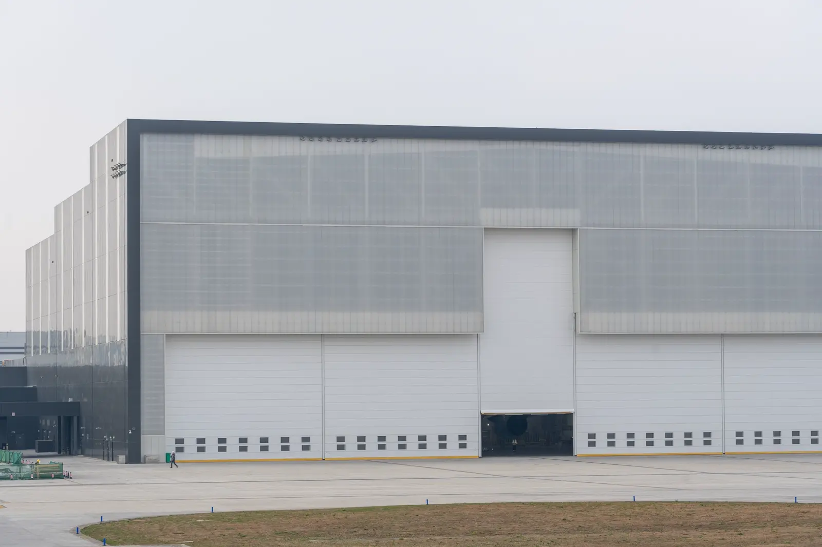The long windowless facade of a modern industrial data facility.