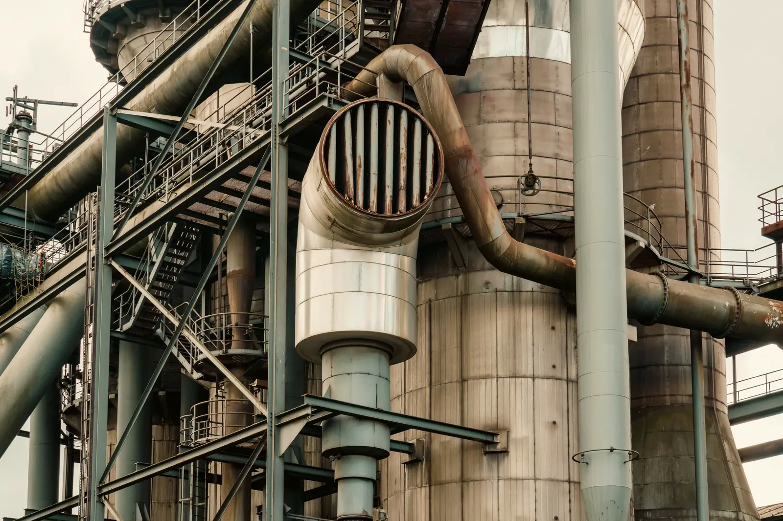 Heavy process piping and vessels at an industrial plant.