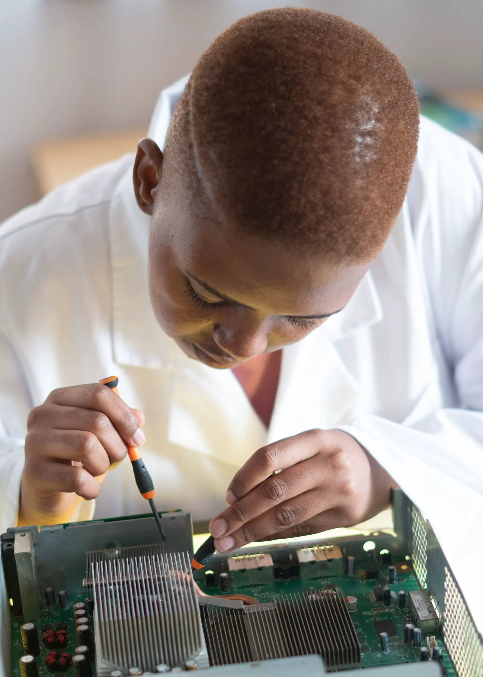 An engineer running a hands-on hardware diagnostic at a repair bench.
